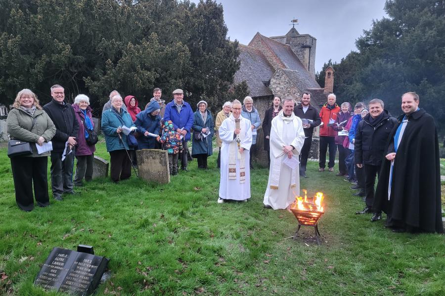 Group photo of congregation around fire.jpg