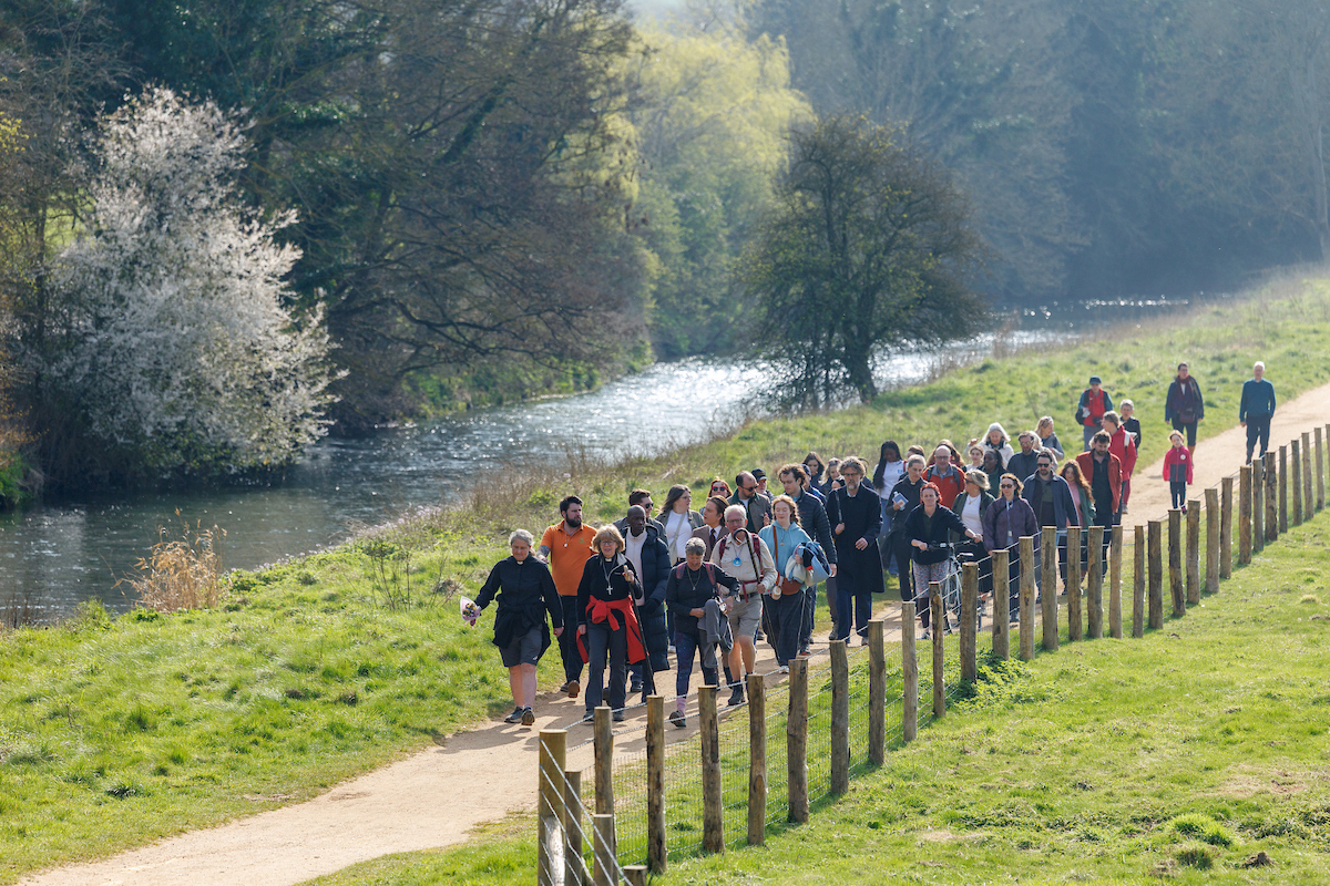 pilgrims walking on a riverside path