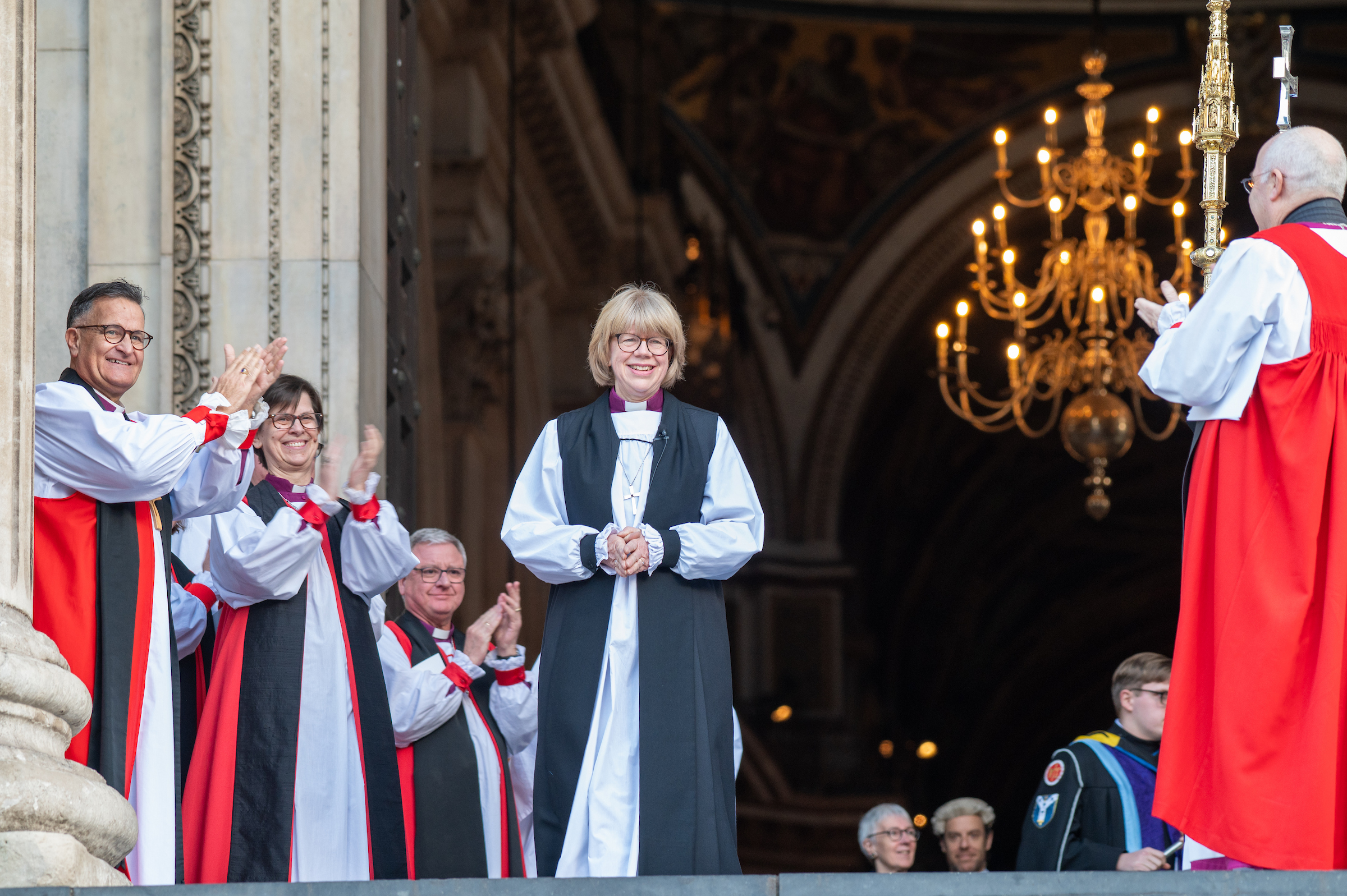 Archbishop Sarah walking out of St Paul's cathedral to applause from bishops