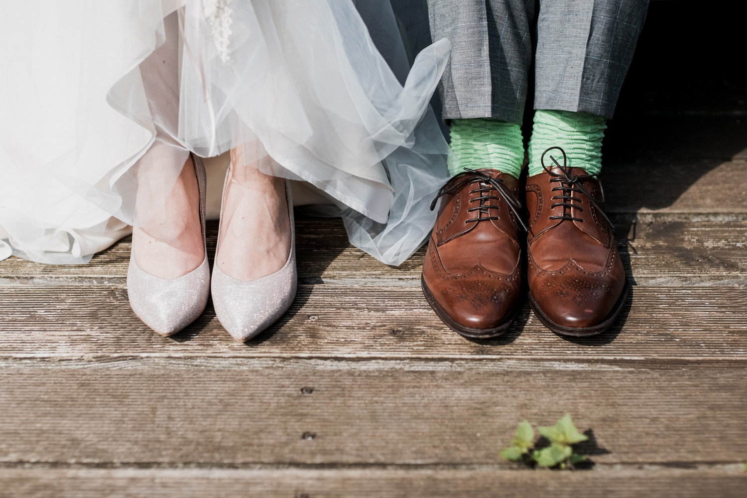 Feet of bride and groom on wooden floor