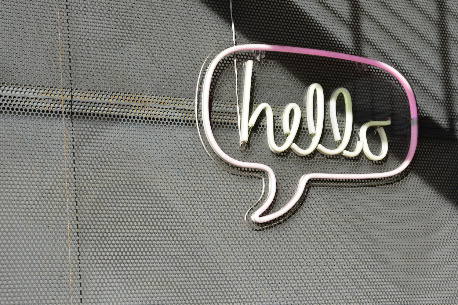 Neon sign with a speech bubble reading 'Hello'